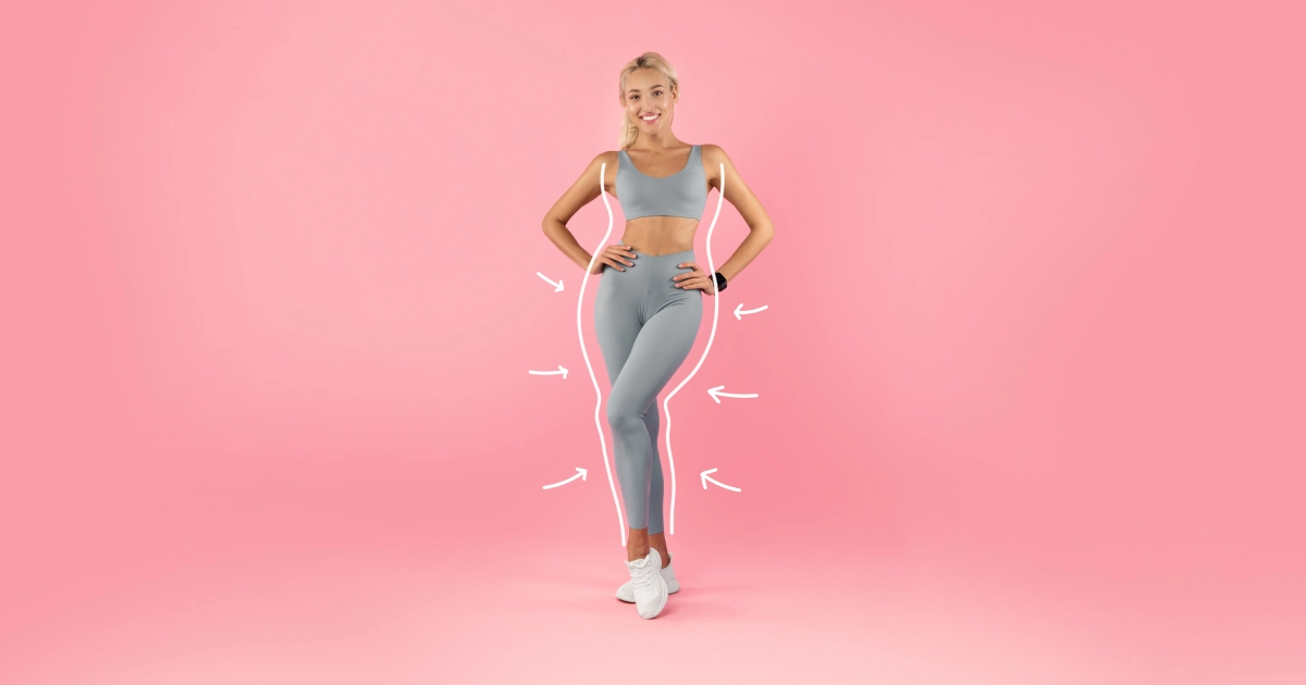Smiling blonde woman in gray workout clothes with arrows on pink background, representing Cryo Slimming in Missoula, MT.