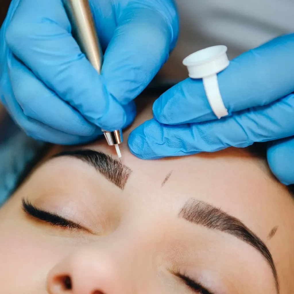 Close-up of a client receiving eyebrow treatments, enhancing brow shape.