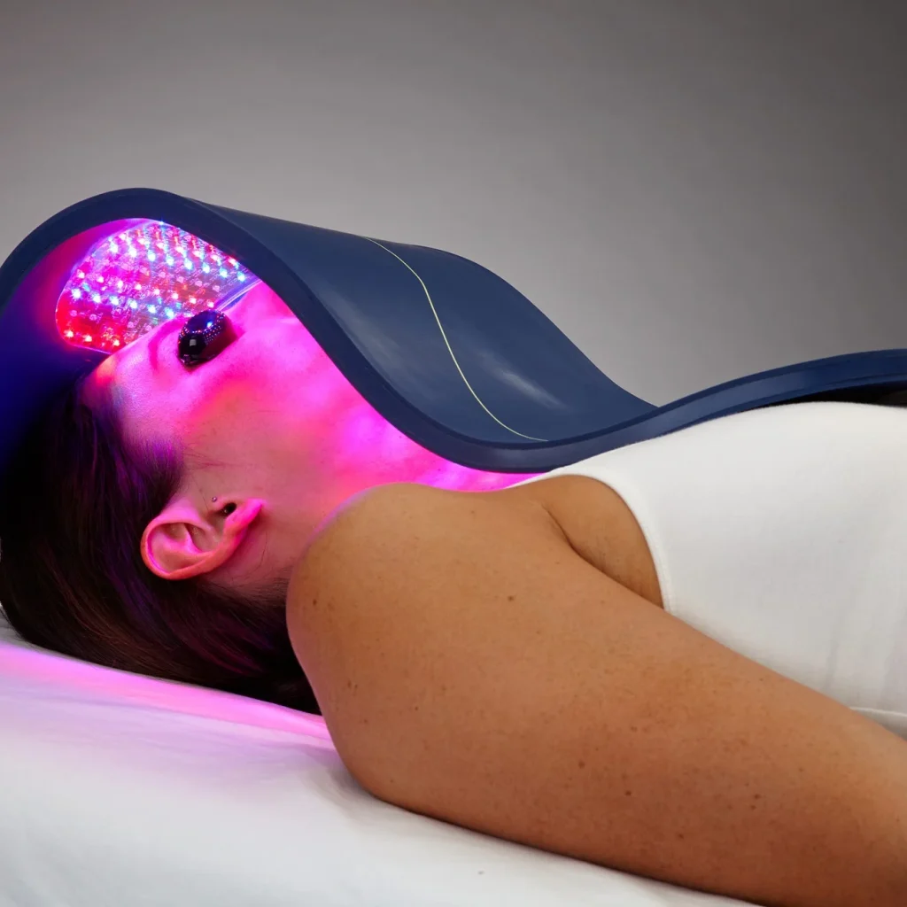 A woman undergoing LED therapy with a light-emitting mask for skin rejuvenation.
